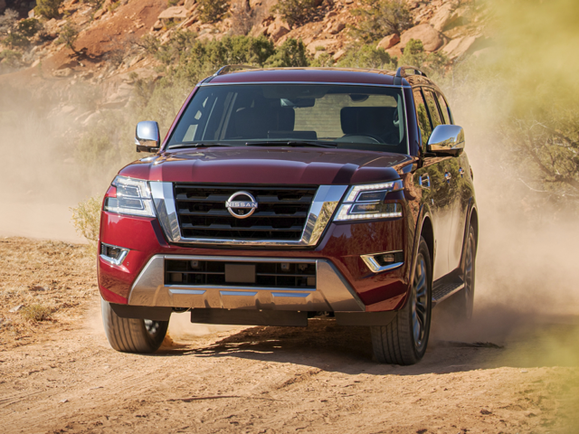A red 2024 Nissan Armada being driven on a dirt road in a park | Nissan dealer in Norfolk, VA | Banister Nissan of Norfolk
