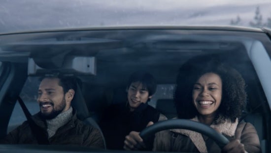 Three passengers riding in a vehicle and smiling | Banister Nissan of Norfolk in Norfolk VA