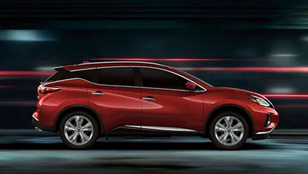 2023 Nissan Murano shown in profile driving down a street at night illustrating performance. | Banister Nissan of Norfolk in Norfolk VA